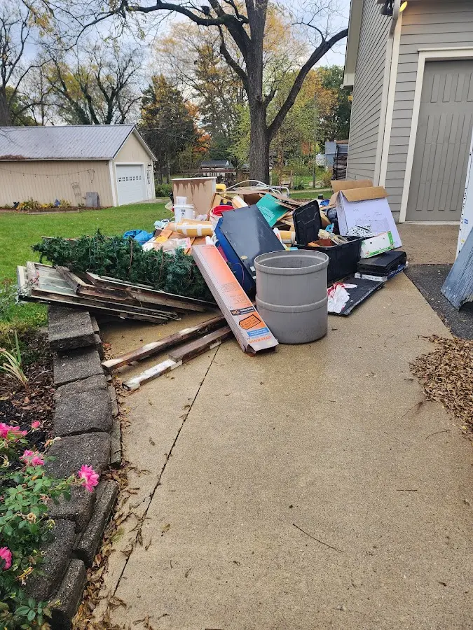 Dumpster being loaded with debris for Estate Cleanout Dumpster Rental in Floyd